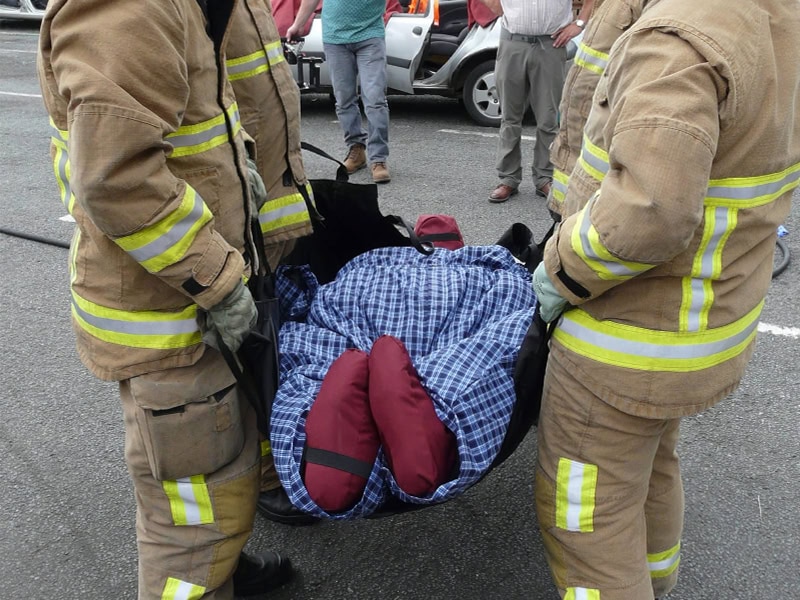 Medical team moving an injured person with a transfer carry sheet