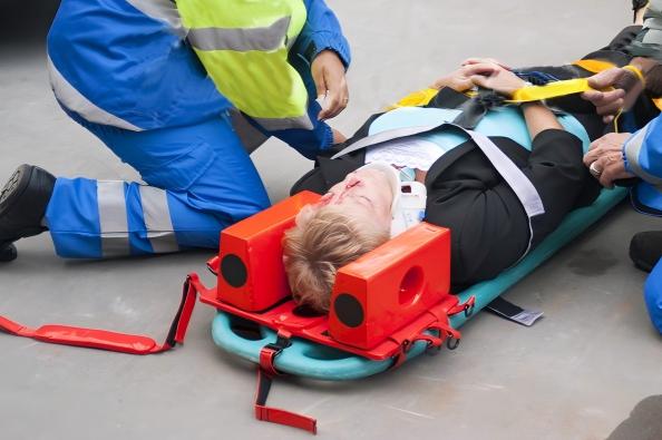 Patient immobilized on spine board with head blocks