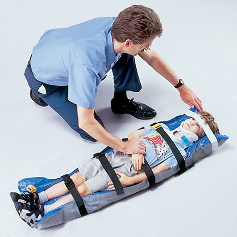 EMS immobilizing child on pediatric spine board