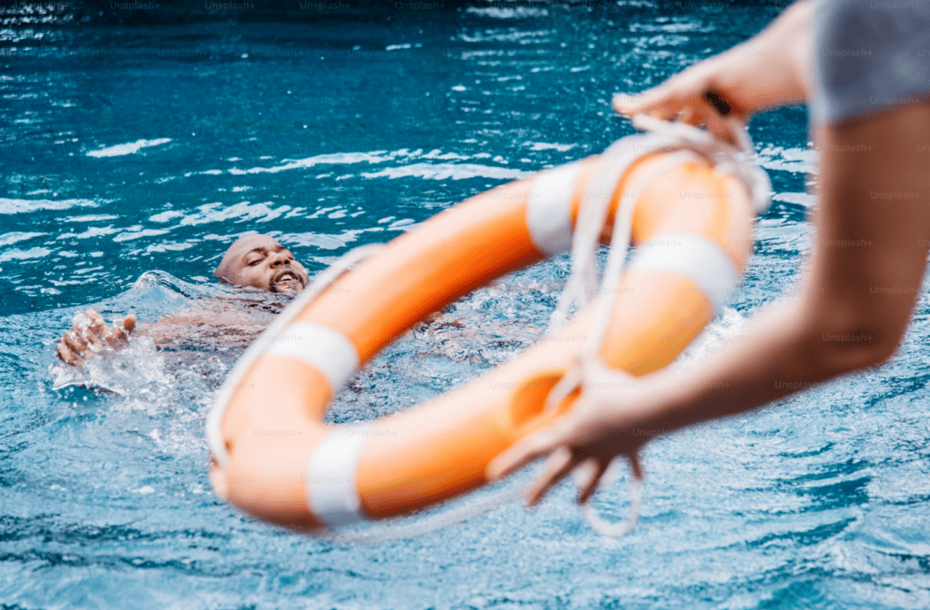 Throwing life ring to drowning swimmer