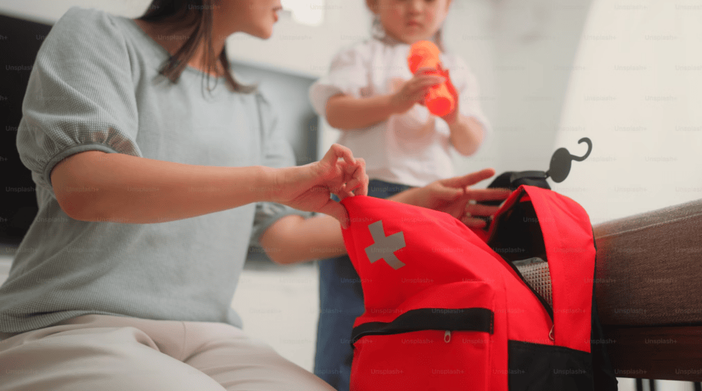 Mother Packing Emergency First Aid Kit at Home