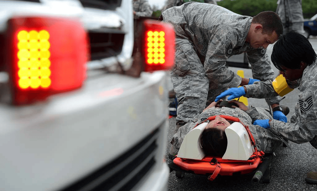 U.S. Air Force emergency medical responders strapping a patient on a stretcher