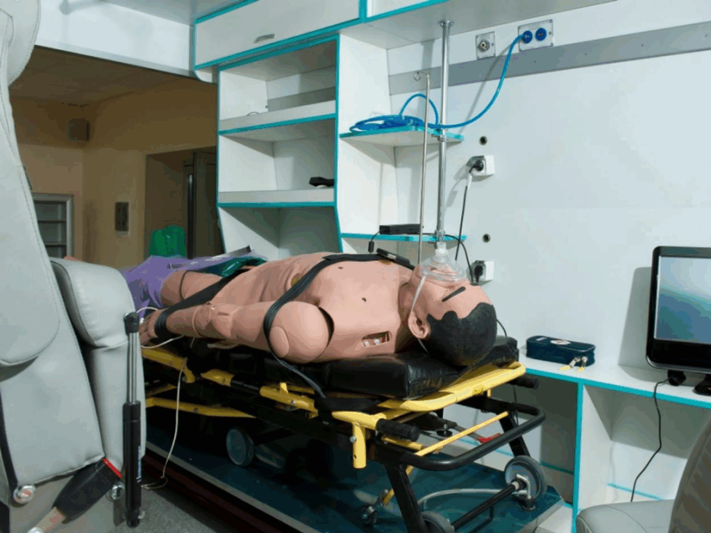 Medical training mannequin on ambulance stretcher
