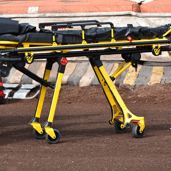 Ambulance stretcher with adjustable legs, side rails, and patient restraints for secure transport